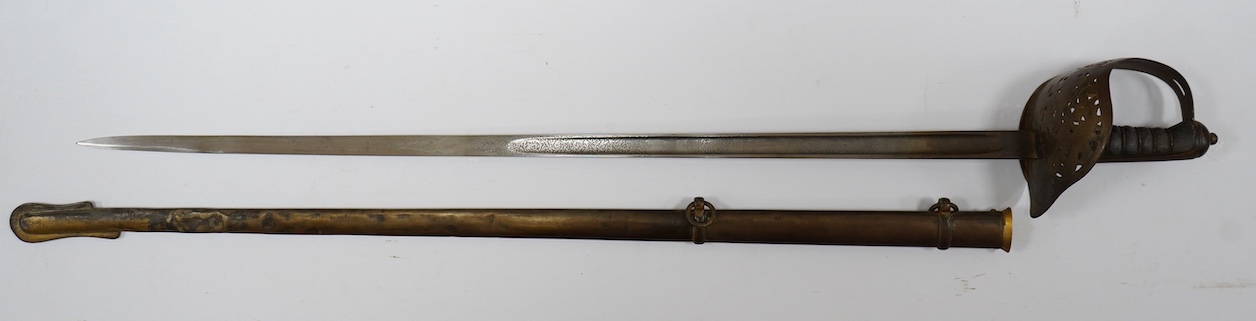 An Edward VII 1897 pattern infantry officer’s sword by Wilkinson, number 40202, blade etched with regulation designs and owners initials; KDA, regulation guard in its steel scabbard. Condition - fair, scabbard badly dent